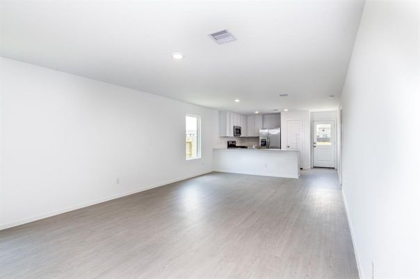 Empty room, Interior, Kitchen, Recessed Lighting, Stainless Steel Appliances, Wood Texture Flooring
