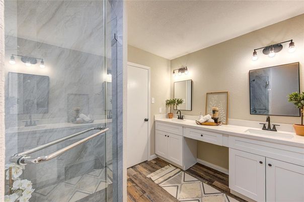 Bathroom, Dual Sink Vanities, Glass Shower, Interior, Marble Walls, Wood Texture Flooring
