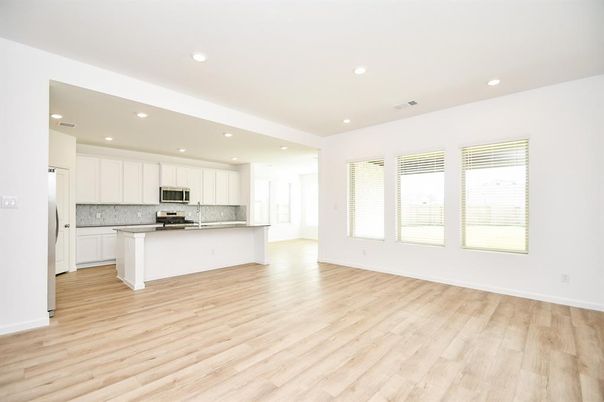 Empty room, Interior, Kitchen, Recessed Lighting, Stainless Steel Appliances, Wood Texture Flooring