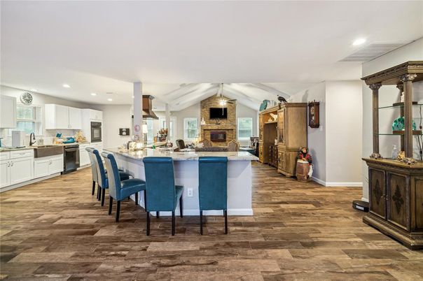 Fireplace, Interior, Kitchen, Recessed Lighting, Stainless Steel Appliances, Wood Texture Flooring