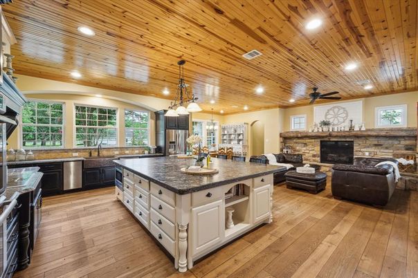 Fireplace, Interior, Kitchen, Living room, Pendant Lights, Recessed Lighting, Stainless Steel Appliances, Stone Walls, Wooden Ceilings, Wood Texture Flooring