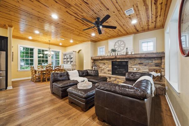 Chandelier, Dining room, Fireplace, Interior, Living room, Recessed Lighting, Stone Walls, Wooden Ceilings, Wood Texture Flooring