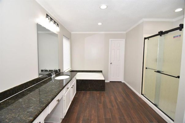 Bathroom, Dual Sink Vanities, Glass Shower, Interior, Recessed Lighting, Wood Texture Flooring