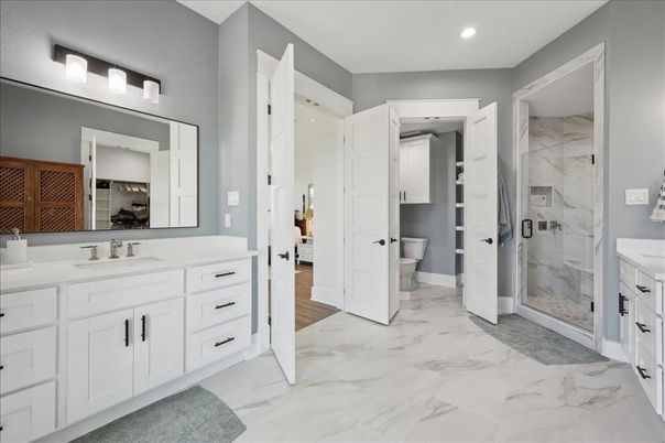 Bathroom, Dual Sink Vanities, Glass Shower, Interior, Marble, Marble Walls, Recessed Lighting