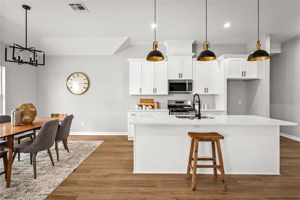 Dining room, Interior, Kitchen, Pendant Lights, Recessed Lighting, Stainless Steel Appliances, Wood Texture Flooring