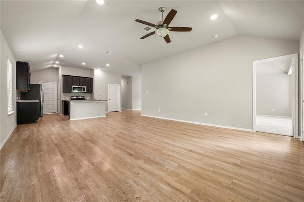 Empty room, Interior, Kitchen, Recessed Lighting, Stainless Steel Appliances, Wood Texture Flooring