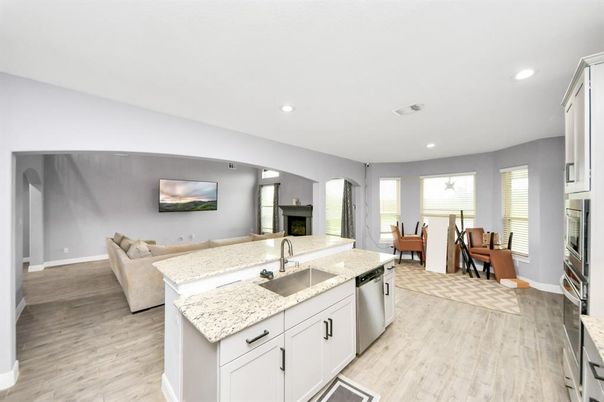 Dining room, Fireplace, Interior, Kitchen, Living room, Recessed Lighting, Stainless Steel Appliances, Wood Texture Flooring