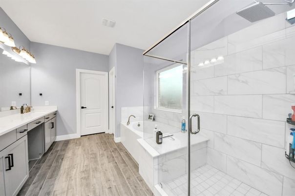 Bathroom, Dual Sink Vanities, Glass Shower, Interior, Marble Walls, Wood Texture Flooring