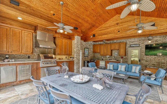 Dining room, Interior, Kitchen, Living room, Recessed Lighting, Stainless Steel Appliances, Stone Walls, Wooden Ceilings