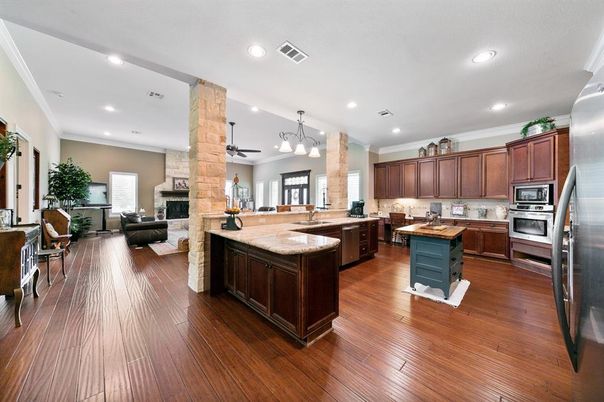 Fireplace, Interior, Kitchen, Living room, Pendant Lights, Recessed Lighting, Stainless Steel Appliances, Wood Texture Flooring