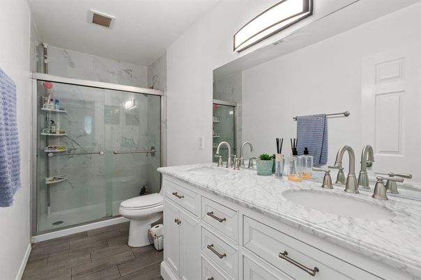 Bathroom, Dual Sink Vanities, Glass Shower, Interior, Marble Walls, Wood Texture Flooring