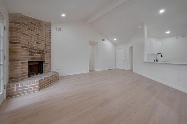 Empty room, Fireplace, Interior, Recessed Lighting, Stone Walls, Wood Texture Flooring