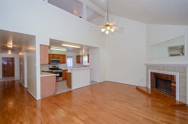 Empty room, Fireplace, Interior, Kitchen, Stainless Steel Appliances, Wood Texture Flooring