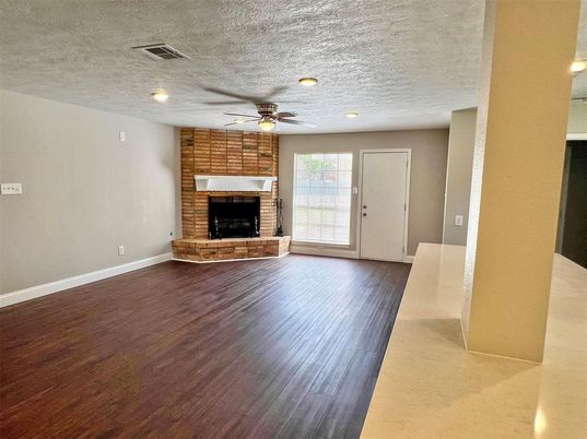 Empty room, Fireplace, Interior, Recessed Lighting, Stone Walls, Wood Texture Flooring
