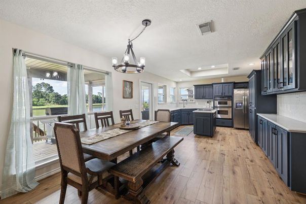 Chandelier, Dining room, Interior, Kitchen, Pendant Lights, Recessed Lighting, Stainless Steel Appliances, Wood Texture Flooring