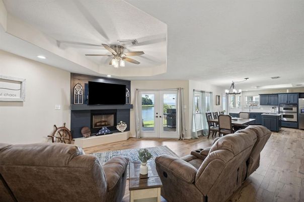 Chandelier, Dining room, Fireplace, Interior, Kitchen, Living room, Recessed Lighting, Stainless Steel Appliances, Wood Texture Flooring