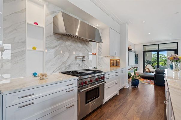 Interior, Kitchen, Marble Walls, Recessed Lighting, Stainless Steel Appliances, Wood Texture Flooring