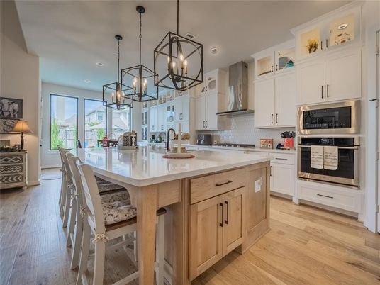Dining room, Interior, Kitchen, Pendant Lights, Recessed Lighting, Stainless Steel Appliances, Wood Texture Flooring