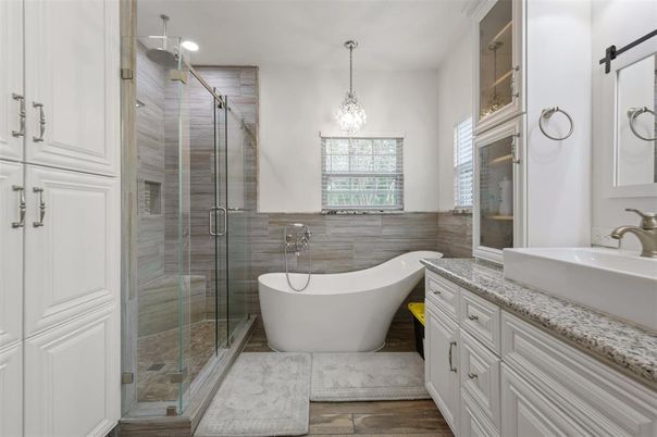 Bathroom, Chandelier, Free Standing Baths, Glass Shower, Interior, Pendant Lights, Recessed Lighting, Wood Texture Flooring