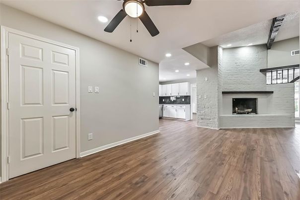 Empty room, Fireplace, Interior, Kitchen, Recessed Lighting, Stone Walls, Wood Texture Flooring