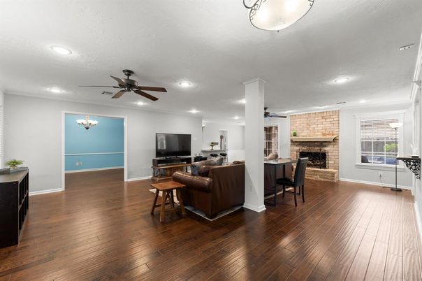 Dining room, Fireplace, Interior, Living room, Recessed Lighting, Stone Walls, Wood Texture Flooring
