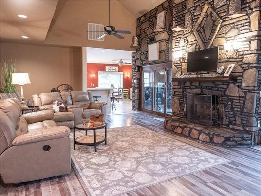 Dining room, Fireplace, Interior, Living room, Recessed Lighting, Stone Walls, Wood Texture Flooring