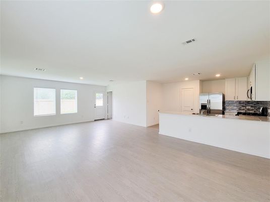 Empty room, Interior, Kitchen, Recessed Lighting, Stainless Steel Appliances, Wood Texture Flooring