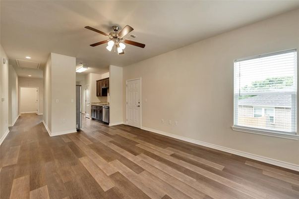 Empty room, Interior, Kitchen, Recessed Lighting, Stainless Steel Appliances, Wood Texture Flooring