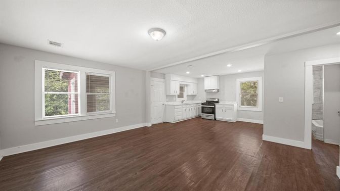 Empty room, Interior, Kitchen, Recessed Lighting, Stainless Steel Appliances, Wood Texture Flooring