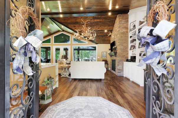 Chandelier, Fireplace, Interior, Living room, Recessed Lighting, Stone Walls, Wooden Ceilings, Wood Texture Flooring