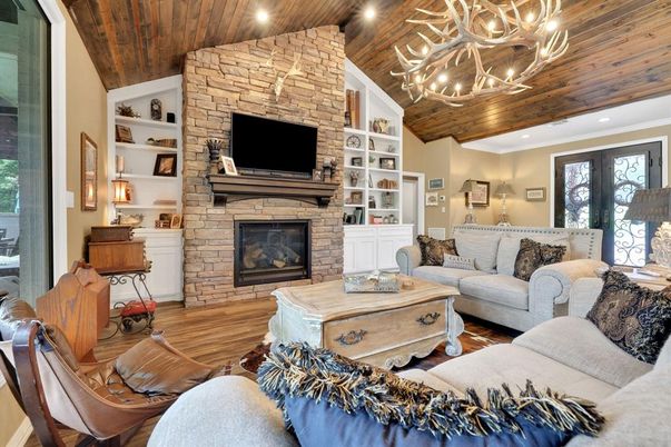 Chandelier, Fireplace, Interior, Living room, Recessed Lighting, Stone Walls, Wooden Ceilings, Wood Texture Flooring