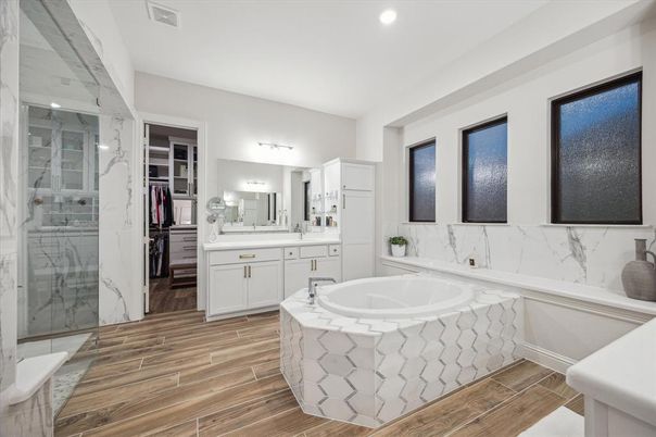 Bathroom, Dual Sink Vanities, Glass Shower, Interior, Marble Walls, Recessed Lighting, Wood Texture Flooring