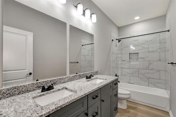 Bathroom, Dual Sink Vanities, Interior, Marble Walls, Recessed Lighting, Wood Texture Flooring
