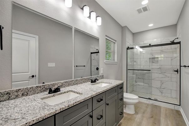 Bathroom, Dual Sink Vanities, Glass Shower, Interior, Marble Walls, Recessed Lighting, Wood Texture Flooring