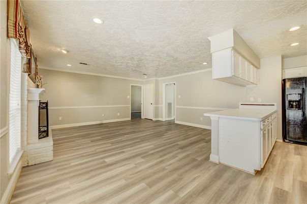 Empty room, Fireplace, Interior, Kitchen, Recessed Lighting, Wood Texture Flooring