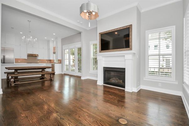 Chandelier, Empty room, Fireplace, Interior, Kitchen, Pendant Lights, Recessed Lighting, Stainless Steel Appliances, Wood Texture Flooring