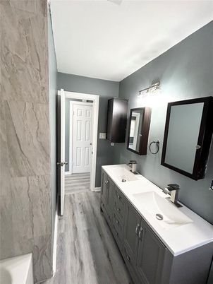 Bathroom, Dual Sink Vanities, Interior, Marble Walls, Wood Texture Flooring