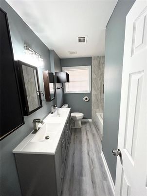 Bathroom, Dual Sink Vanities, Interior, Marble Walls, Wood Texture Flooring