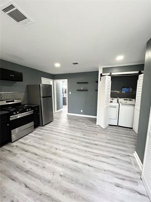 Interior, Kitchen, Recessed Lighting, Stainless Steel Appliances, Washer, Wood Texture Flooring
