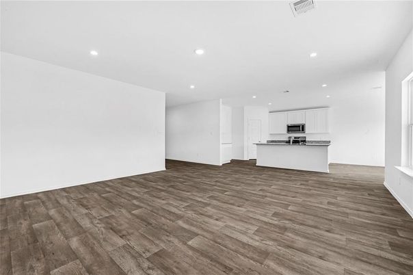 Empty room, Interior, Kitchen, Recessed Lighting, Stainless Steel Appliances, Wood Texture Flooring