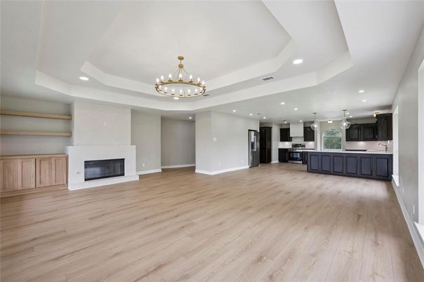 Chandelier, Fireplace, Interior, Kitchen, Pendant Lights, Recessed Lighting, Stainless Steel Appliances, Wood Texture Flooring