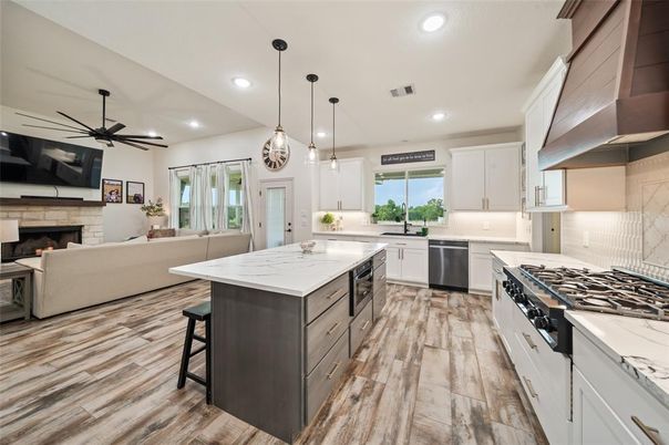 Fireplace, Interior, Kitchen, Living room, Pendant Lights, Recessed Lighting, Stainless Steel Appliances, Wood Texture Flooring