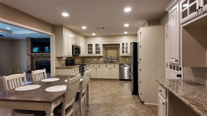 Dining room, Fireplace, Interior, Kitchen, Recessed Lighting, Stainless Steel Appliances, Stone Walls