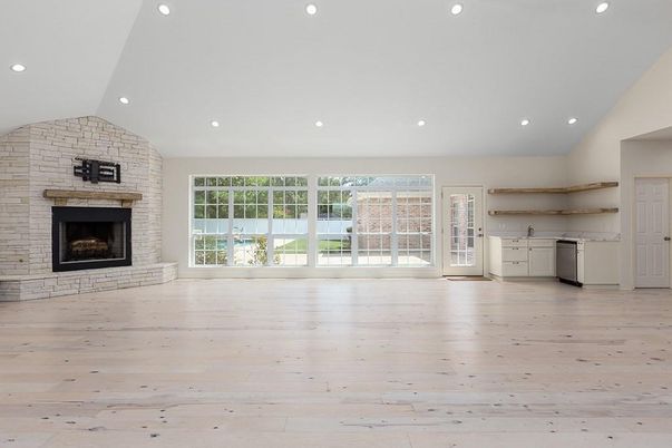 Empty room, Fireplace, Interior, Kitchen, Recessed Lighting, Stone Walls, Wood Texture Flooring