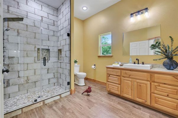 Bathroom, Dual Sink Vanities, Glass Shower, Interior, Recessed Lighting, Stone Walls, Wood Texture Flooring