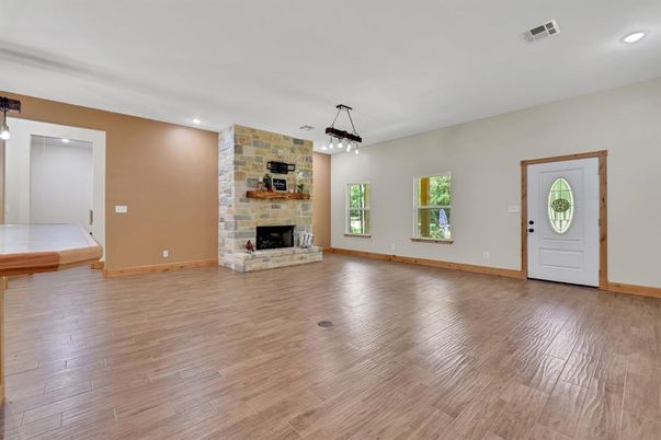 Empty room, Fireplace, Interior, Pendant Lights, Recessed Lighting, Stone Walls, Wood Texture Flooring