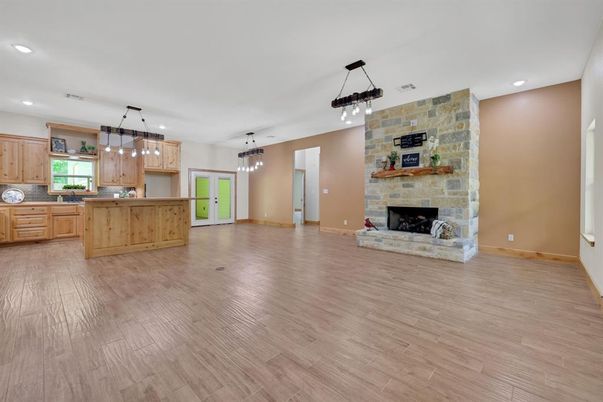 Empty room, Fireplace, Interior, Kitchen, Pendant Lights, Recessed Lighting, Stone Walls, Wood Texture Flooring