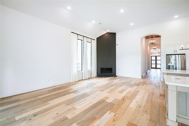 Empty room, Fireplace, Interior, Kitchen, Recessed Lighting, Stainless Steel Appliances, Wood Texture Flooring