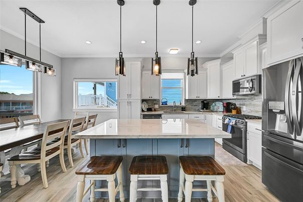Dining room, Interior, Kitchen, Pendant Lights, Recessed Lighting, Stainless Steel Appliances, Water, Wood Texture Flooring