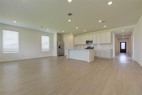 Empty room, Interior, Kitchen, Recessed Lighting, Stainless Steel Appliances, Wood Texture Flooring